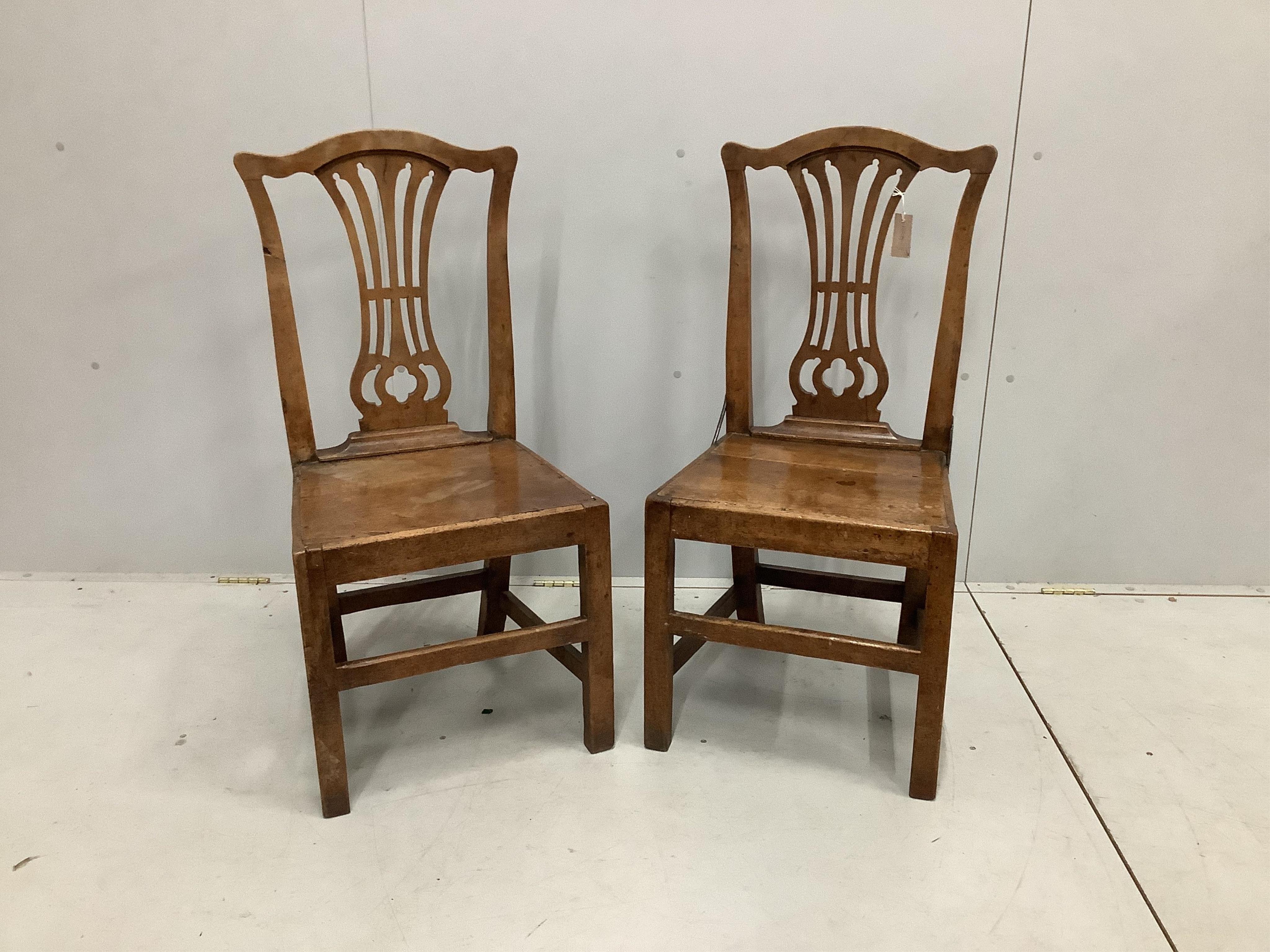 A pair of George III Provincial fruitwood side chairs, with pierced back splats, on square legs, width 46cm, depth 39cm, height 96cm. Condition - fair